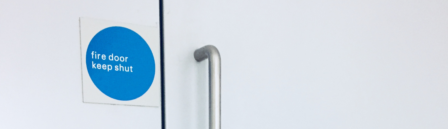 can-you-modify-fire-rated-doors-hero fire door keep shut sign on white door