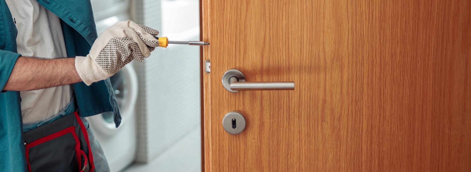 Man installing a door lock