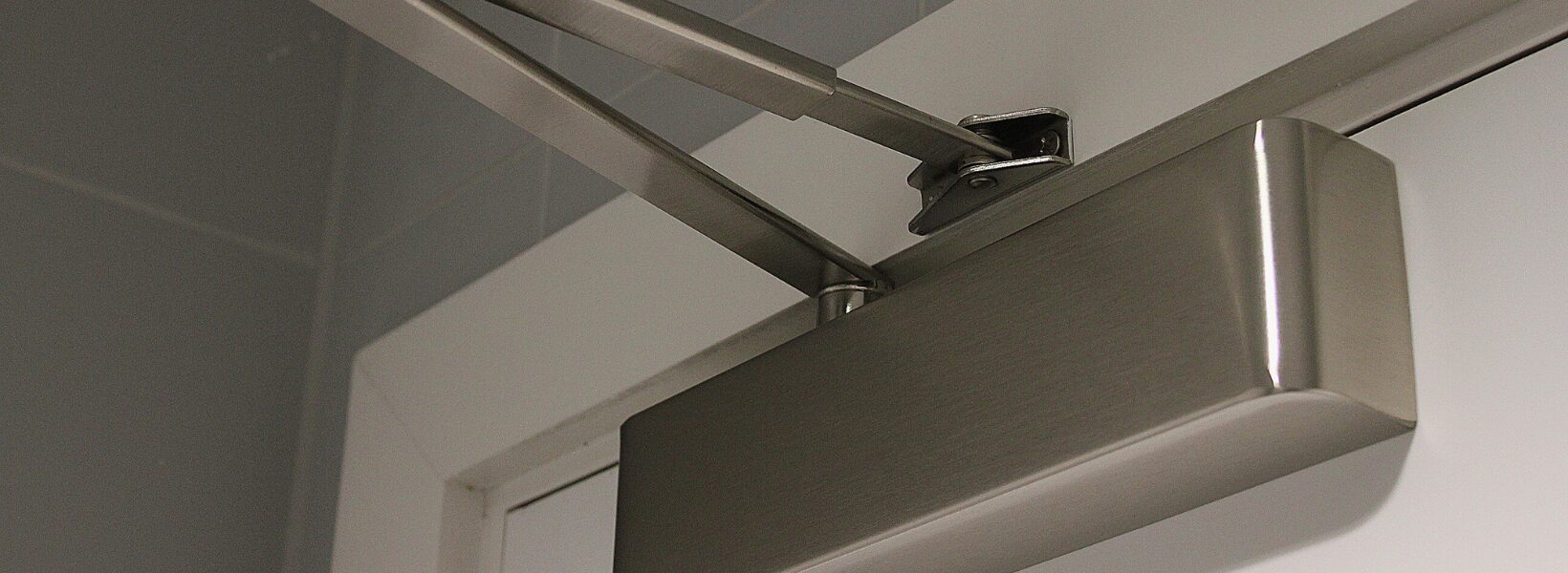 Automatic fire door closer in silver
