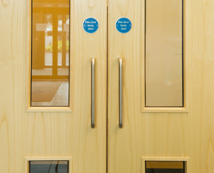 Fire doors with glass panels and fire door keep shut signs