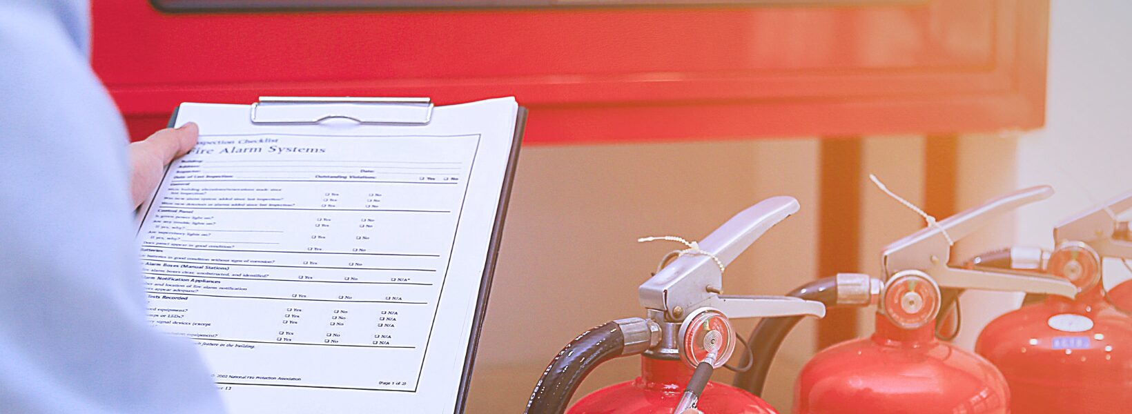 Man inspecting fire extinguishers