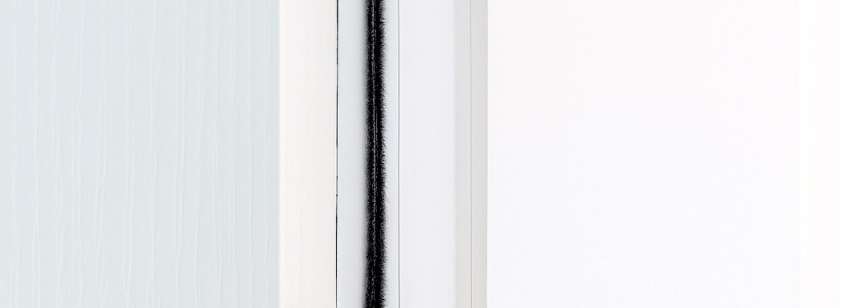 Intumescent strip with brush around fire door frame