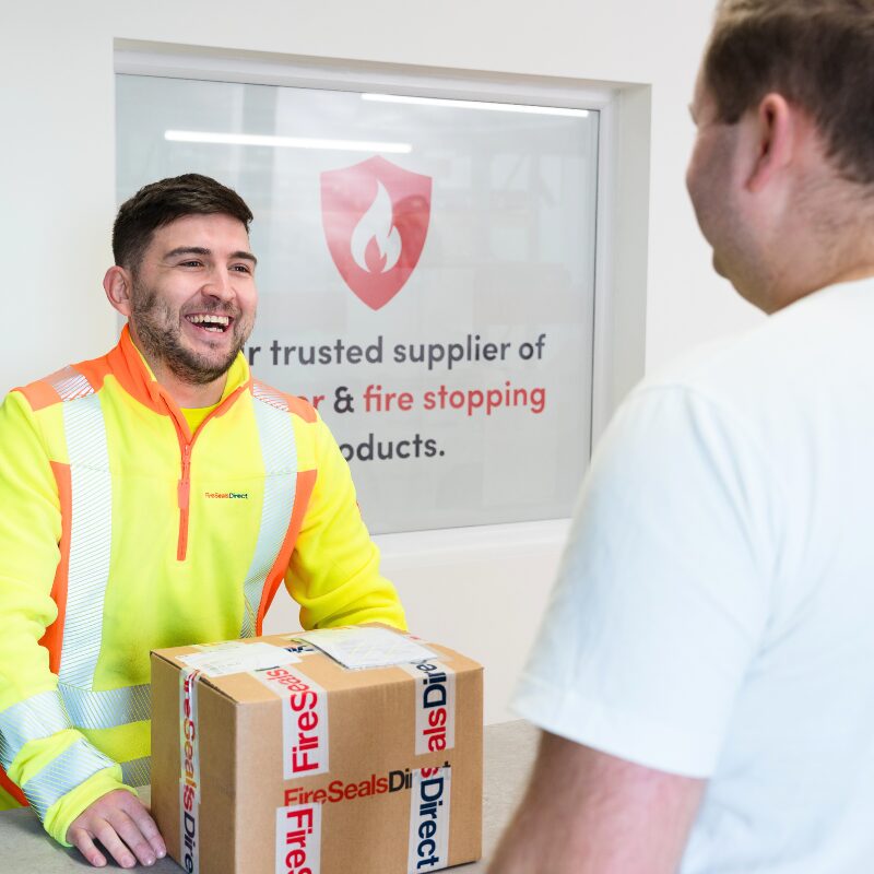 Man handing a parcel to customer
