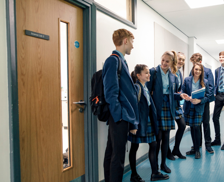 School children waiting outside classroom